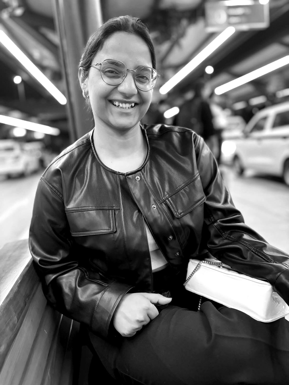 Yukti, smiling, in a black leather jacket